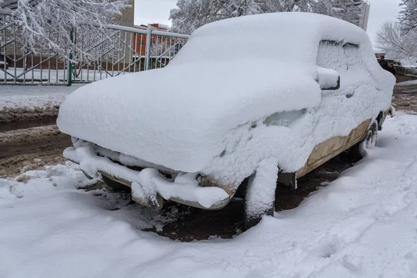 Машина припаркована во дворе, покрытом снегом. Зима — стоковое фото