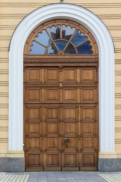 Wooden arched door in the classical style. The Architecture