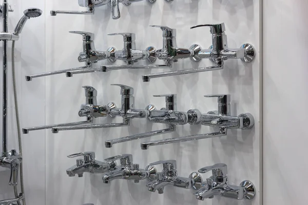 Modern kitchen water faucets in the store. Sale