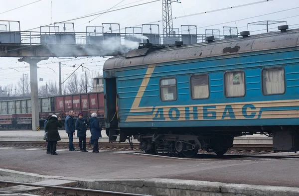 Костантиновка, Украина - 05 декабря 2017 года: пассажиры и старый поезд с надписью "Донбасс" на вокзале — стоковое фото