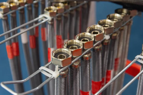 Flexible metal water hoses on the store counter. Plumbing