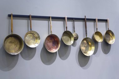 Duvarda eski bakır kızartma tavaları