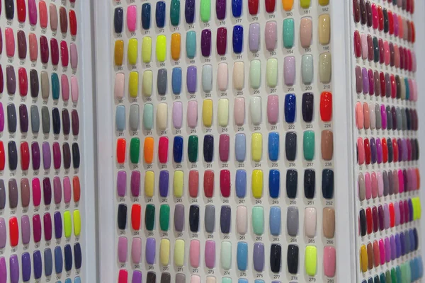 Uñas artificiales de colores en estantes en salón de belleza —  Fotos de Stock