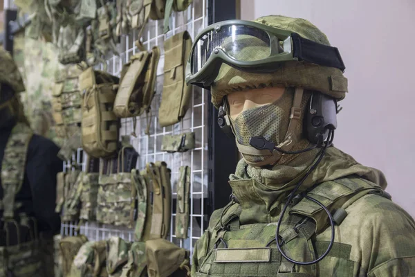 Mannequin in army helmet and camouflage gear. Weaponry