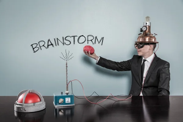 Brainstorm concept with businessman holding brain — Stockfoto