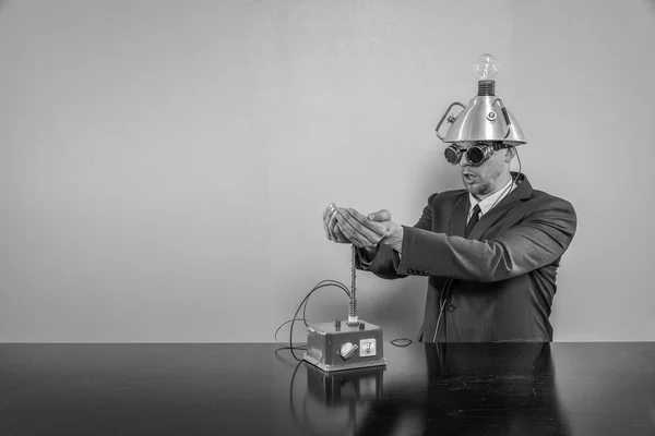 Businessman sitting at office desk with machine — Stock Photo, Image