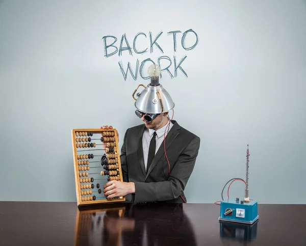 Back to work text on blackboard with businessman — Stock Photo, Image