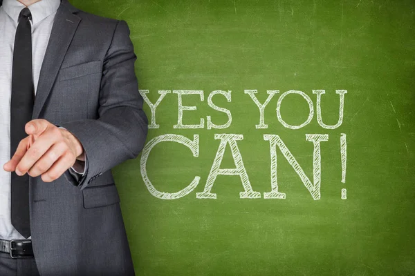 Yes you can on blackboard with businessman — Stockfoto