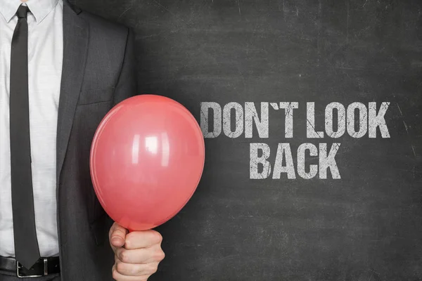 Businessman Holding Balloon By Dont Look Back Text On Blackboard — Stock Photo, Image