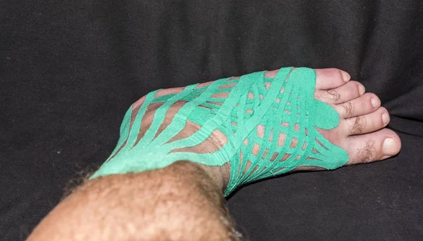 Elastic therapeutic tape left foot injury to the patient.