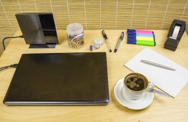 Brewed coffee in a cup on a desk. clipart