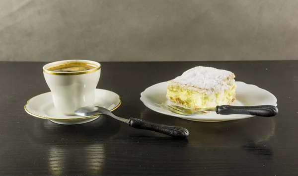 De cake van de Napoleonka en zwarte koffie. — Stockfoto