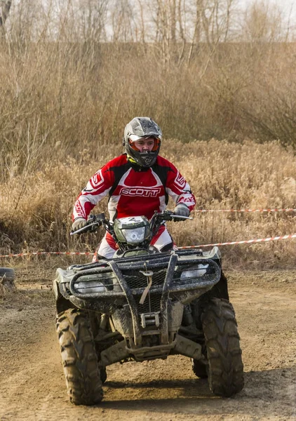 Sopir dalam pakaian dan helm protektif merah saat mengendarai kendaraan all-terrain . — Stok Foto