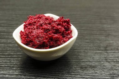 A bowl of grated beetroot with horseradish. clipart