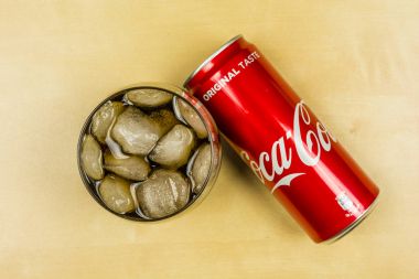 Cult Coca-Cola in a glass with ice cubes. View from above. clipart