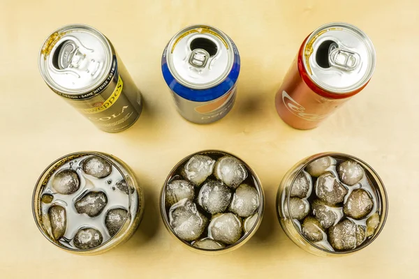 Comparison of a cola drink from producers: Pepsi, Coca-Cola and Schweppes. Cola was poured into glasses with ice cubes. — Stock Photo, Image
