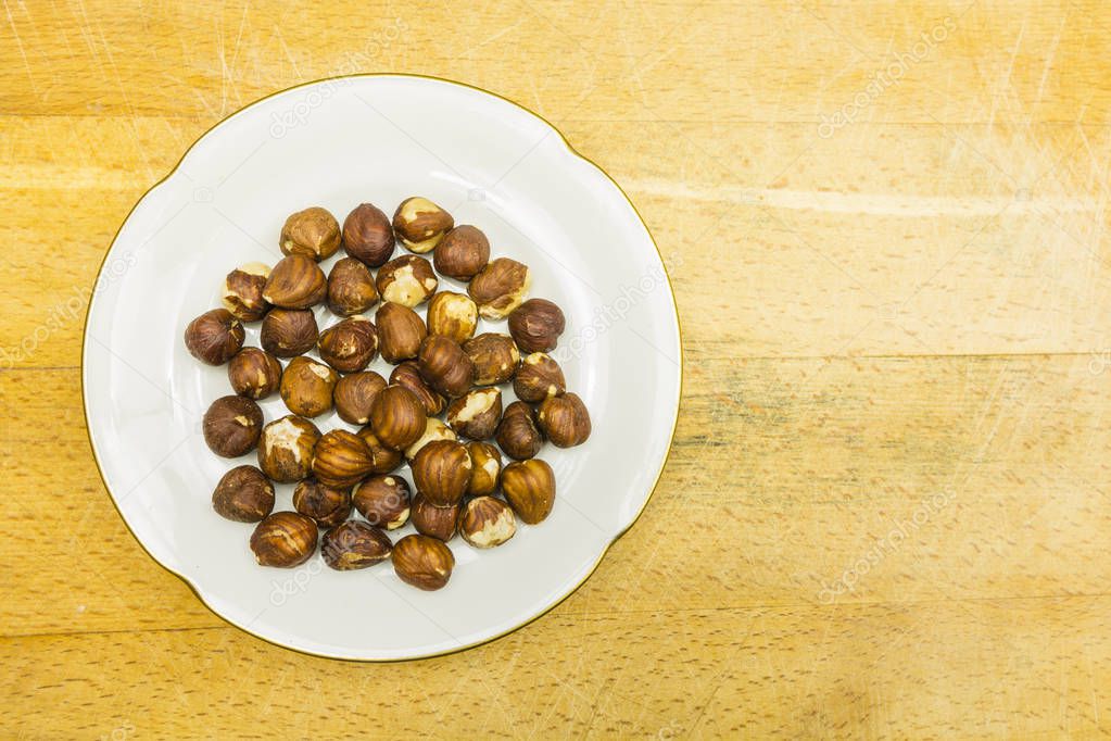 Plate with hazelnuts. View from above.
