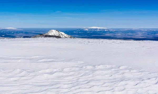 Abstract vision of the sea in the mountains. Snow as a sandy beach, and peaks are emerging islands from the sea. — Stock Photo, Image