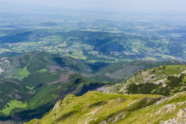 Located in the valley, the village (among others: Koscielisko, Zakopane) in Podhale seen from the trail in the Tatras.