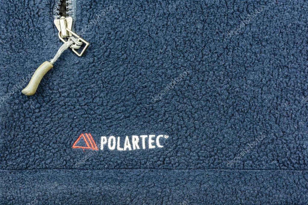 Niedomice, Poland - November 21, 2019: Polartec logo placed on navy blue fleece material.