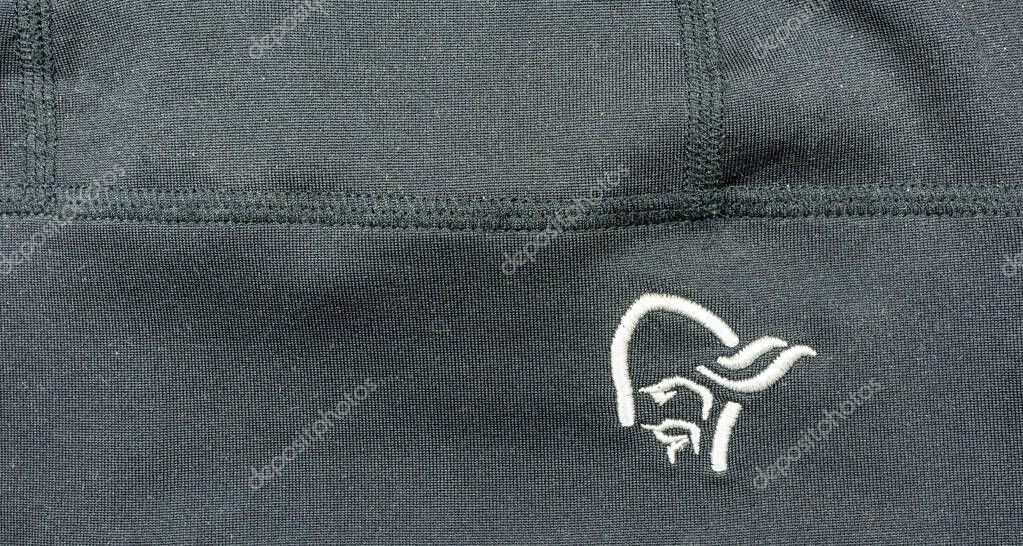 Niedomice, Poland - November 21, 2019: Norrona logo on dark material. Norwegian company from the outdoor industry.
