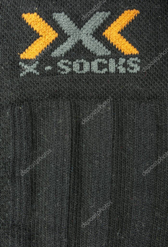Niedomice, Poland - November 21, 2019: X-Socks logo on black fabric. Swiss manufacturer of sport socks.