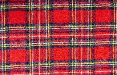Tartan - a material with a classic Scottish pattern. Pattern consisting of criss-crossed horizontal and vertical bands in multiple colours. clipart
