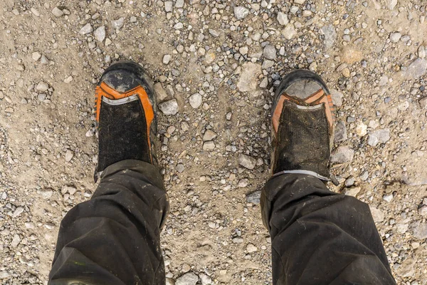 Dirty mountaineering boots and pants after a mountain trip.