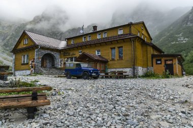 Tatranska Lomnica, Slovakya - 14 Eylül 2019: Tatra Dağları 'ndaki Chata pri Zelenom savunmasının altında off-road otomobili Mercedes 250 gd Wolf. Zirveler arasında bulutlar dönüyor.
