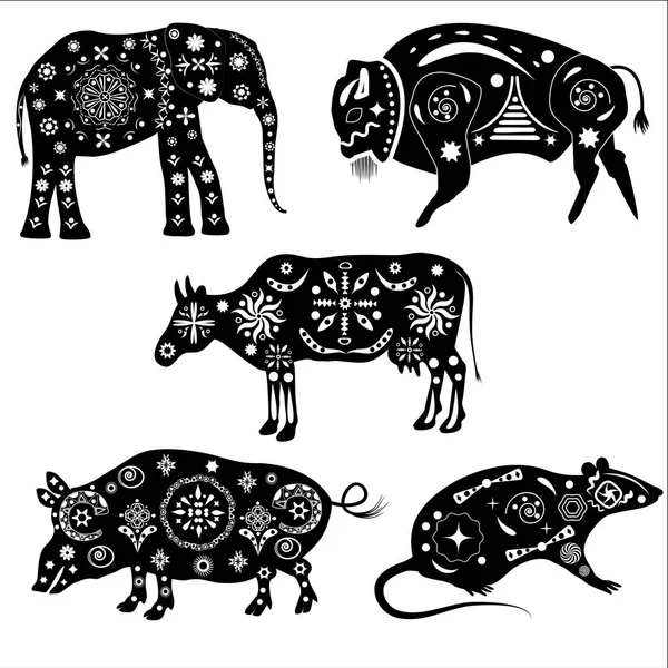 A set of silhouettes of animals with patterns. Elephant, buffalo — Stock Vector