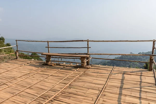 Wooden bench on wooden floor near cliff.  rustic bench outdoor park — Stock Photo, Image