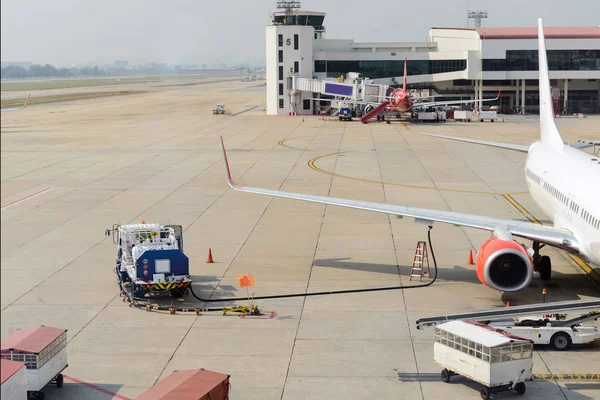 Airplane receiving fuel from tanker truck