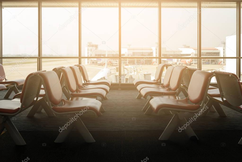 Departure lounge with empty chairs in the terminal of airport, waiting area