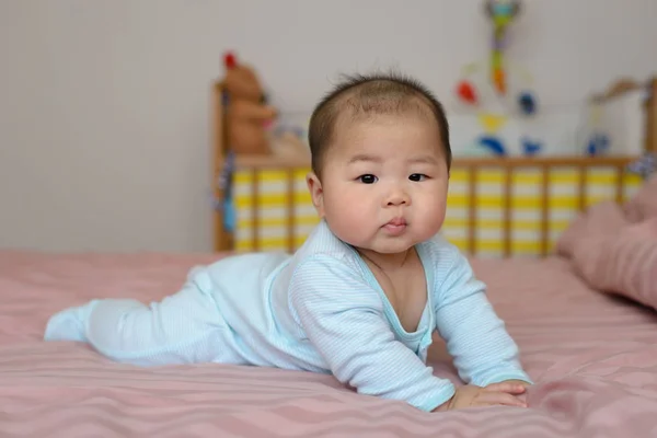 亚洲宝贝男孩小 7 个月大的画像。在他的房间的床上戴一顶帽子 — 图库照片