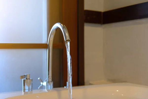 Vand fra vandhane til badekar i badeværelse - Stock-foto