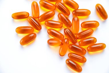 Fish oil capsules with copy space on a white background. soft gels capsules with copy space clipart