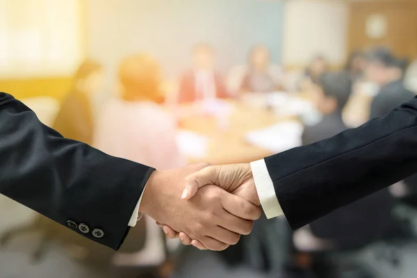 Double exposure Businessman and businesswoman handshake with blurred of business Meeting - Business successful Concept. — Stock Photo, Image