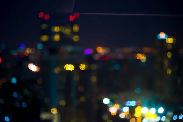 Resumen de la luz nocturna de la ciudad bokeh - paisaje urbano de fondo —  Fotos de Stock