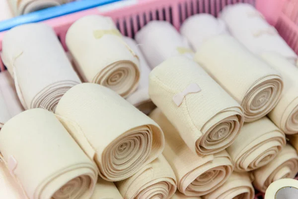 Many bandage rolls in plastic basket