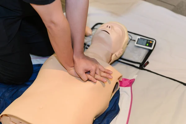 CPR First Aid Training with CPR dummy in the class