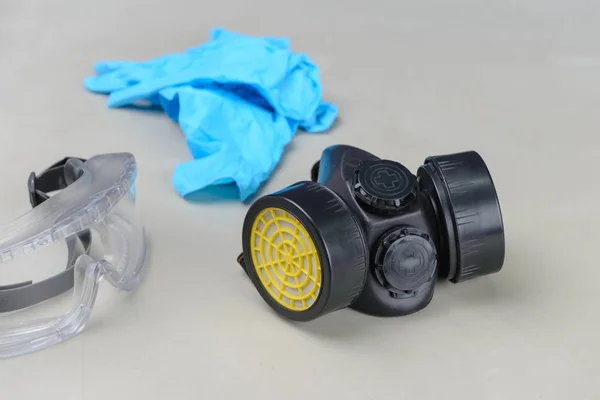 Respirator, Goggles and Blue medical gloves on table