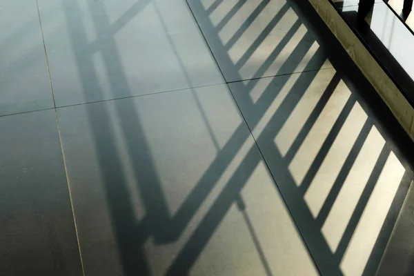 Light of the shadow of stairway on black floor — Stock Photo, Image