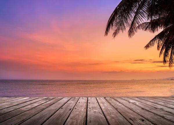 Empty wooden terrace over tropical island beach with coconut palm at sunset or sunrise time — Stock Photo, Image