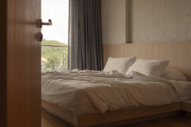 Sabahları rahat bir yatakta yumuşak yastıklı kırışık beyaz battaniye. Gece uykusundan sonra berbat oldu.
