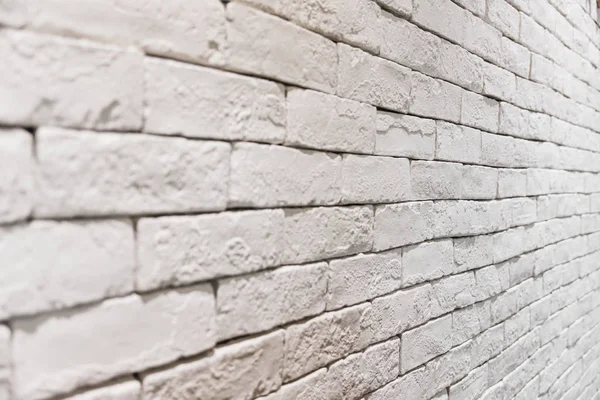 Vista lateral da parede de tijolo branco vazio no quarto. texturizado e fundo — Fotografia de Stock
