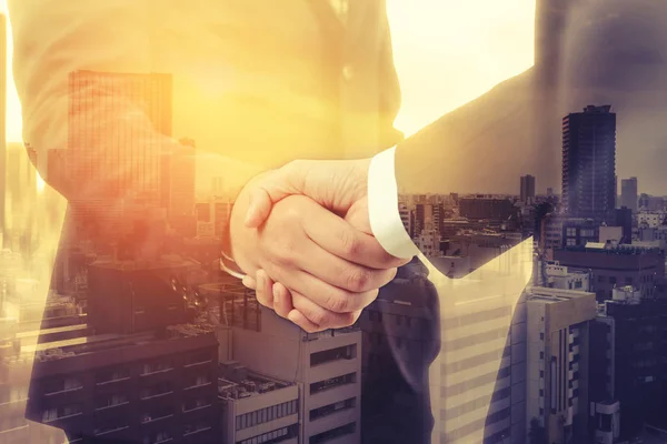 Double exposure of business people handshake with cityscape background. successful of the deal, partnership, teamwork concept — Stock Photo, Image