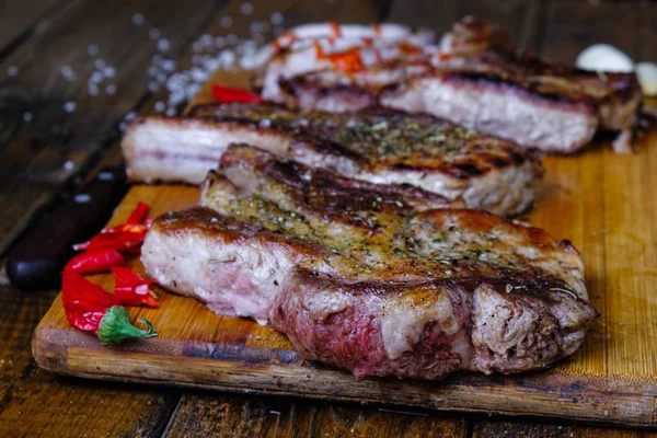 roasted pork loin with ribs on a wooden background