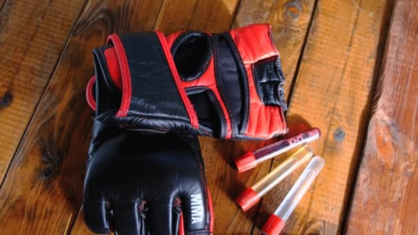 Mma gloves with steroids composition on wooden background — Stock Video