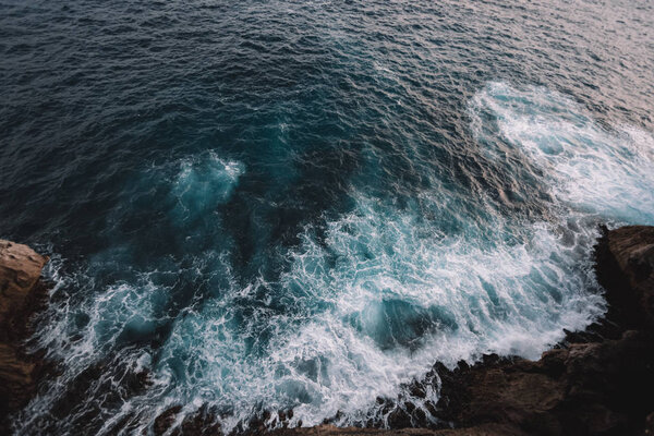 Aerial view to ocean waves and rock coast