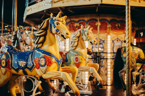 Seat horse on carousel illuminated at night — Stock Photo, Image